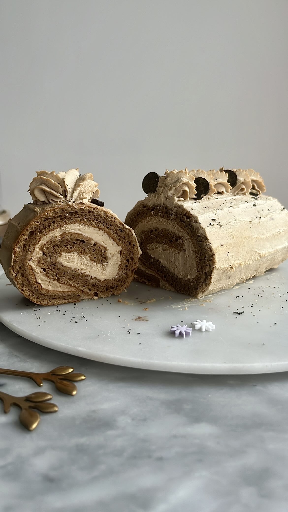 Coffee cake roll filled with coffee cream, and decorated with coffee cream on top