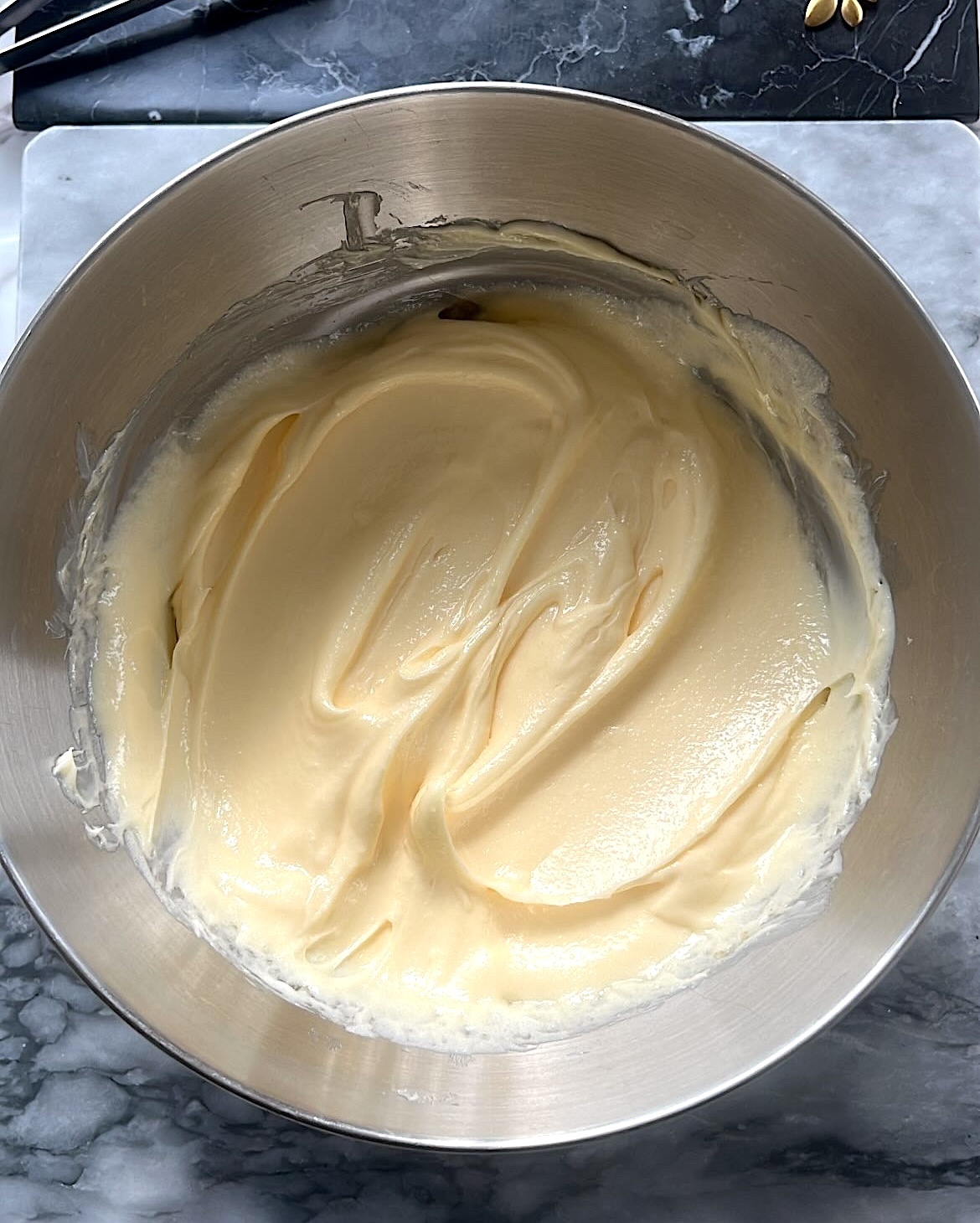 Butter mixed with caster sugar in a bowl.