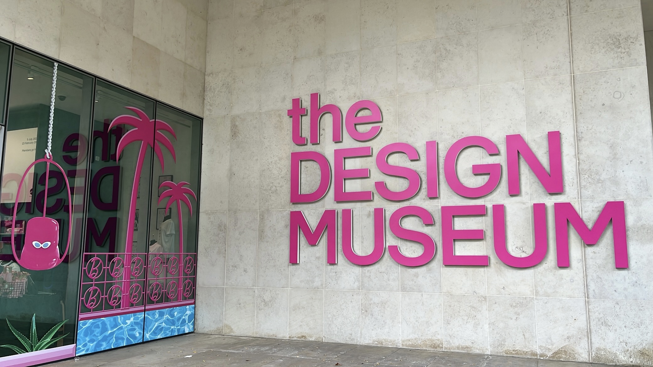 The Design Museum sign painted in pink to match the theme of the Barbie exhibition, blending modern museum branding with the iconic Barbie color palette.