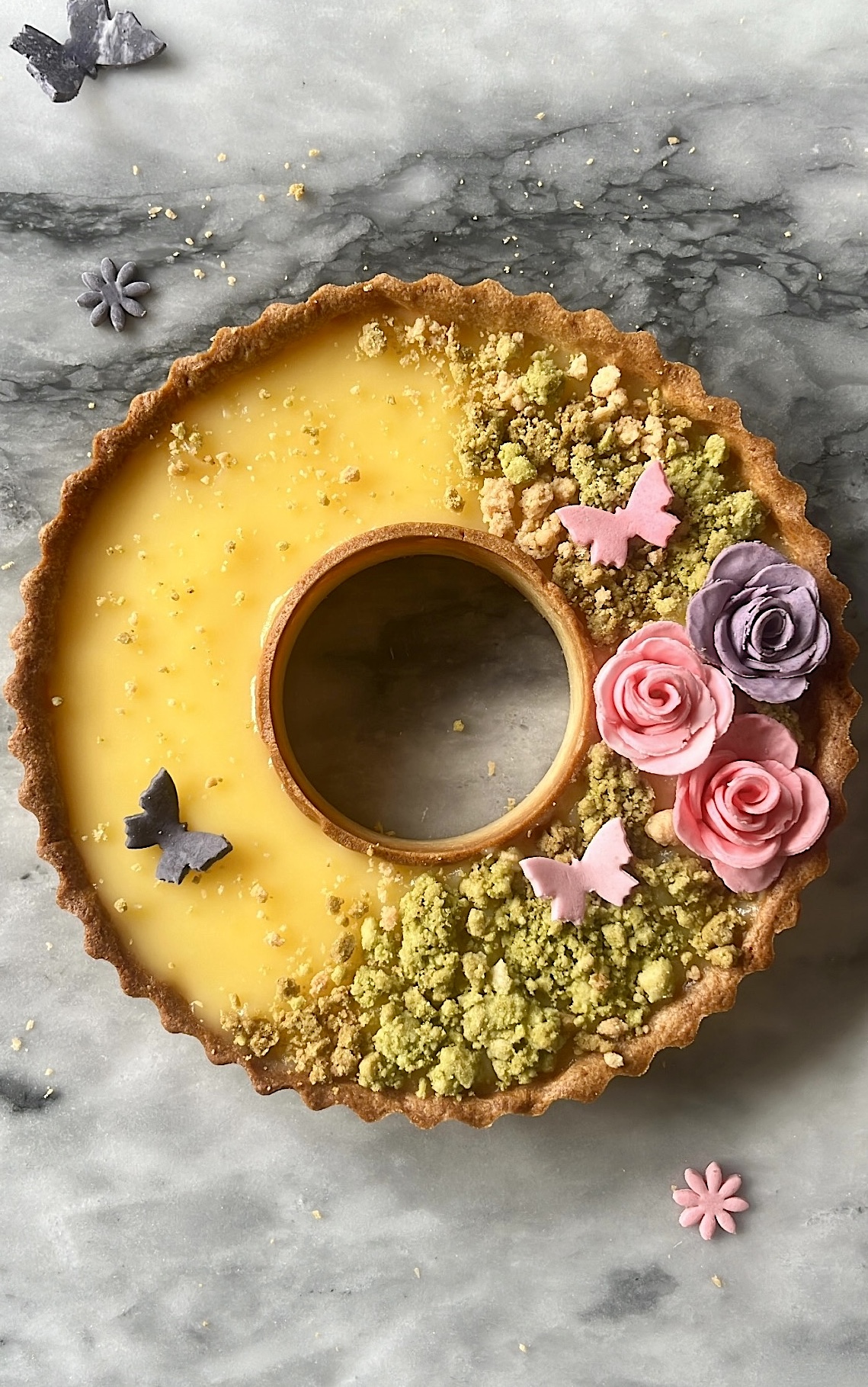 Tart ring with grassland-themed decoration on top, linking to the Lemon Tart recipe.