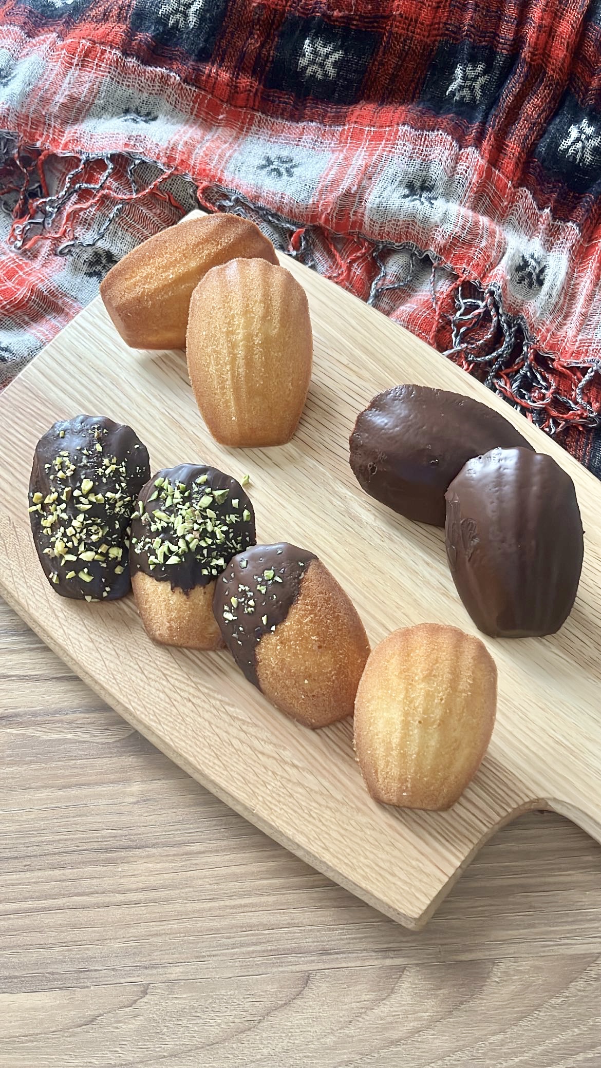 Madeleine, with some dipped in rich chocolate and some topped with pistachio