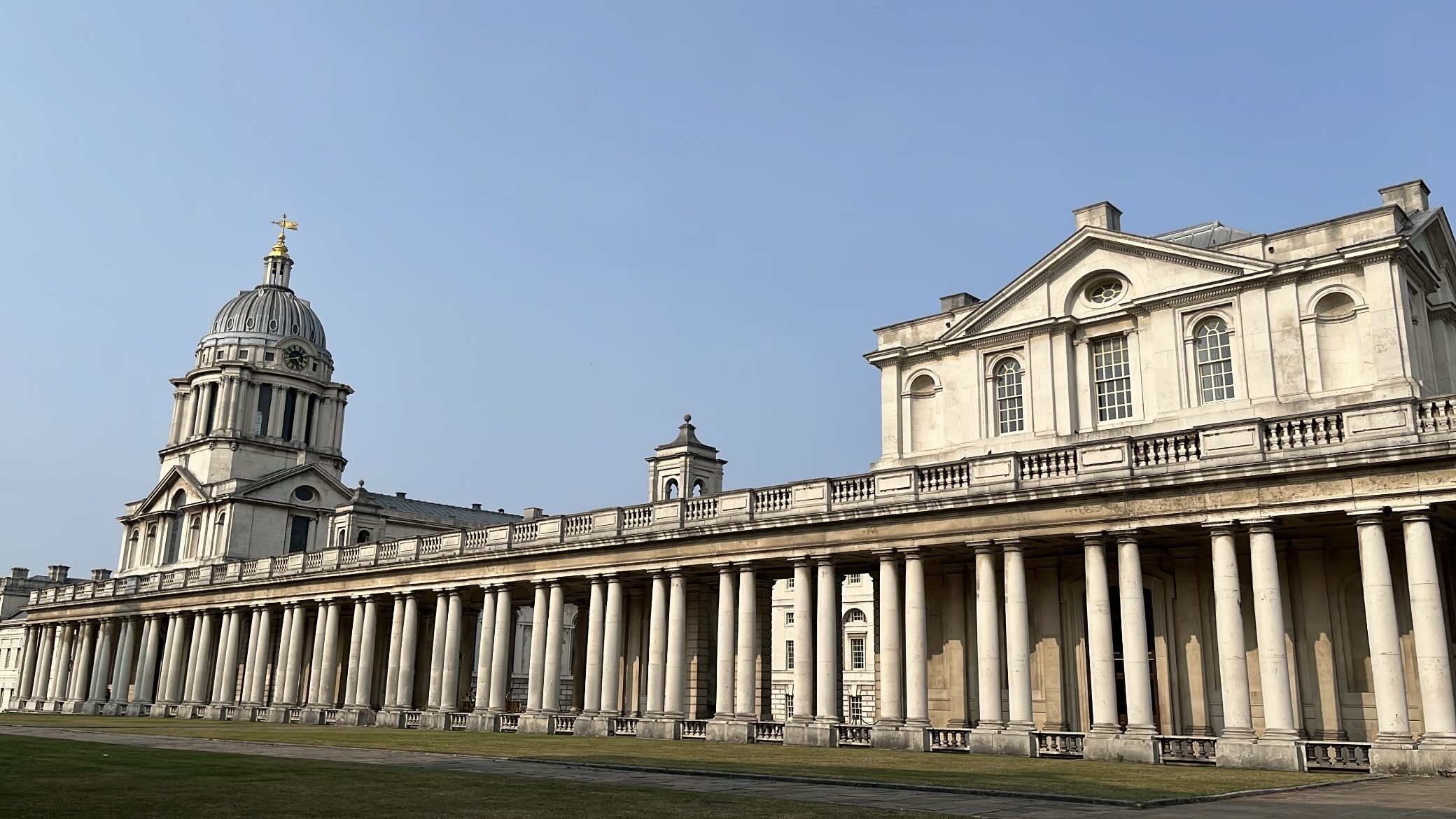 Panoramic view of the Old Royal Naval College in Greenwich, with its iconic domes and neoclassical architecture.