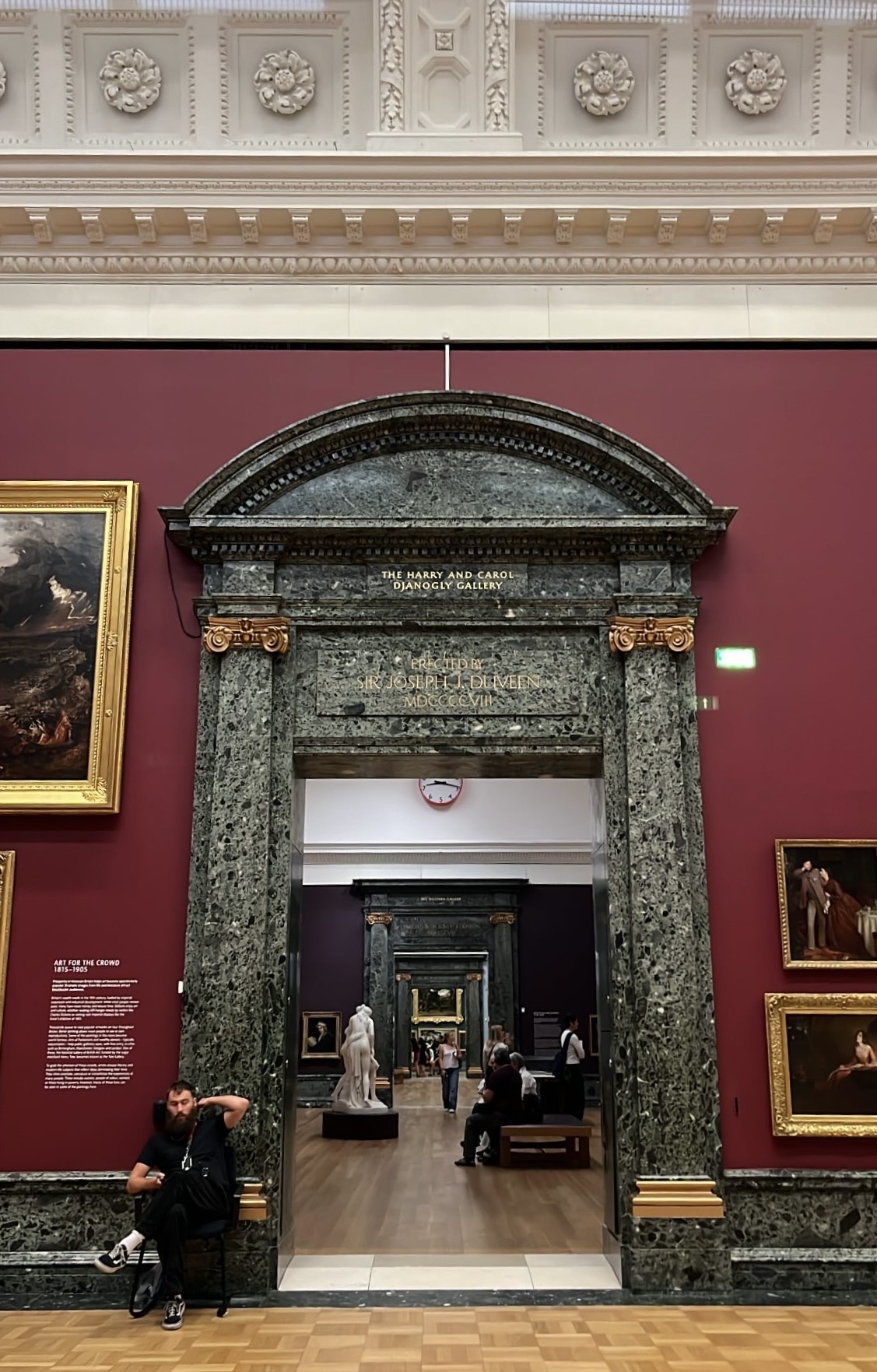 Well-decorated entrance to a gallery room in Tate Britain, featuring elegant architectural details and art displays that invite visitors into the exhibition space.