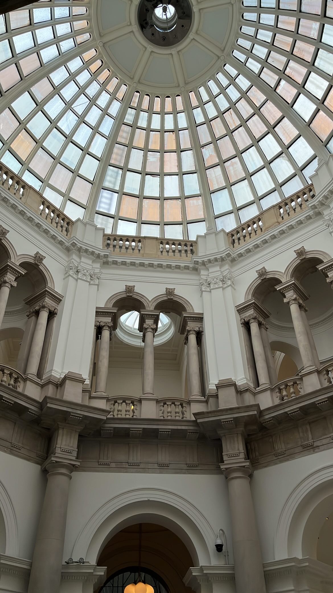 Intricate and richly decorated ceiling of Tate Britain, showcasing elaborate architectural details and craftsmanship as seen upon entering the gallery.