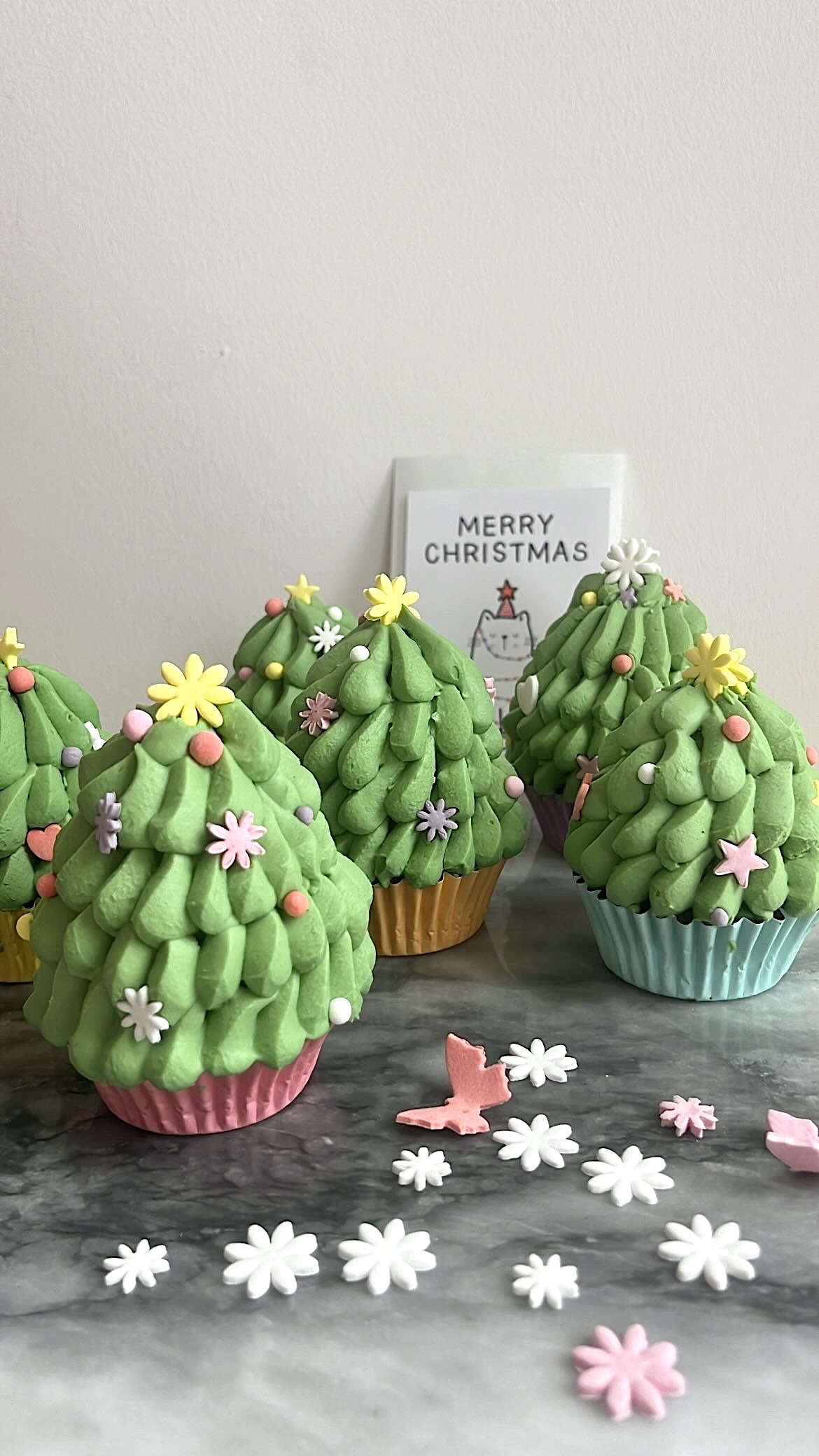 Cupcakes shaped like Christmas tree with matcha cream piped on top, ideal for Christmas celebrations